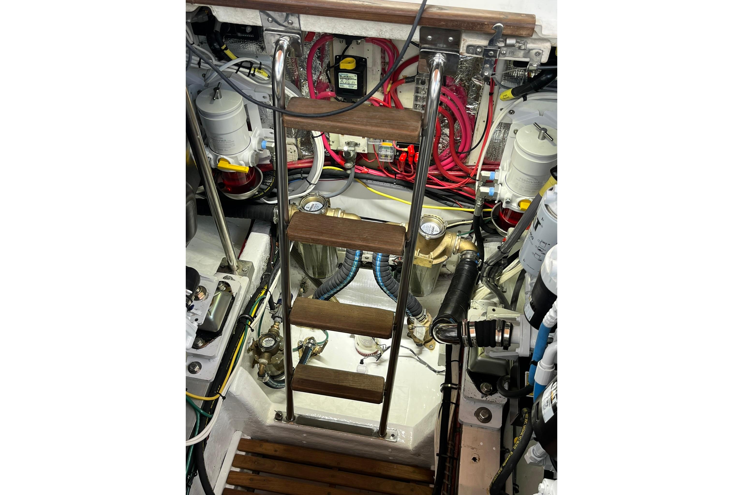 Engine room of 1995 Grand Banks 38 Eastbay EX with ladder and mechanical components.