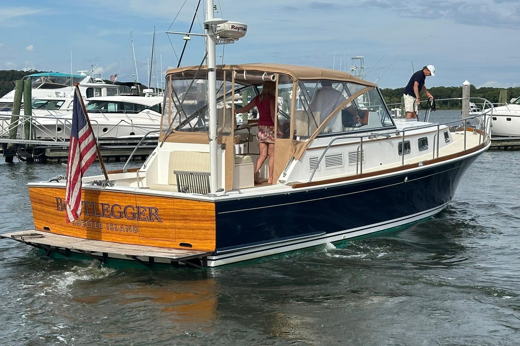 Grand Banks 38 Eastbay EX 1995 boat in harbor with flag.