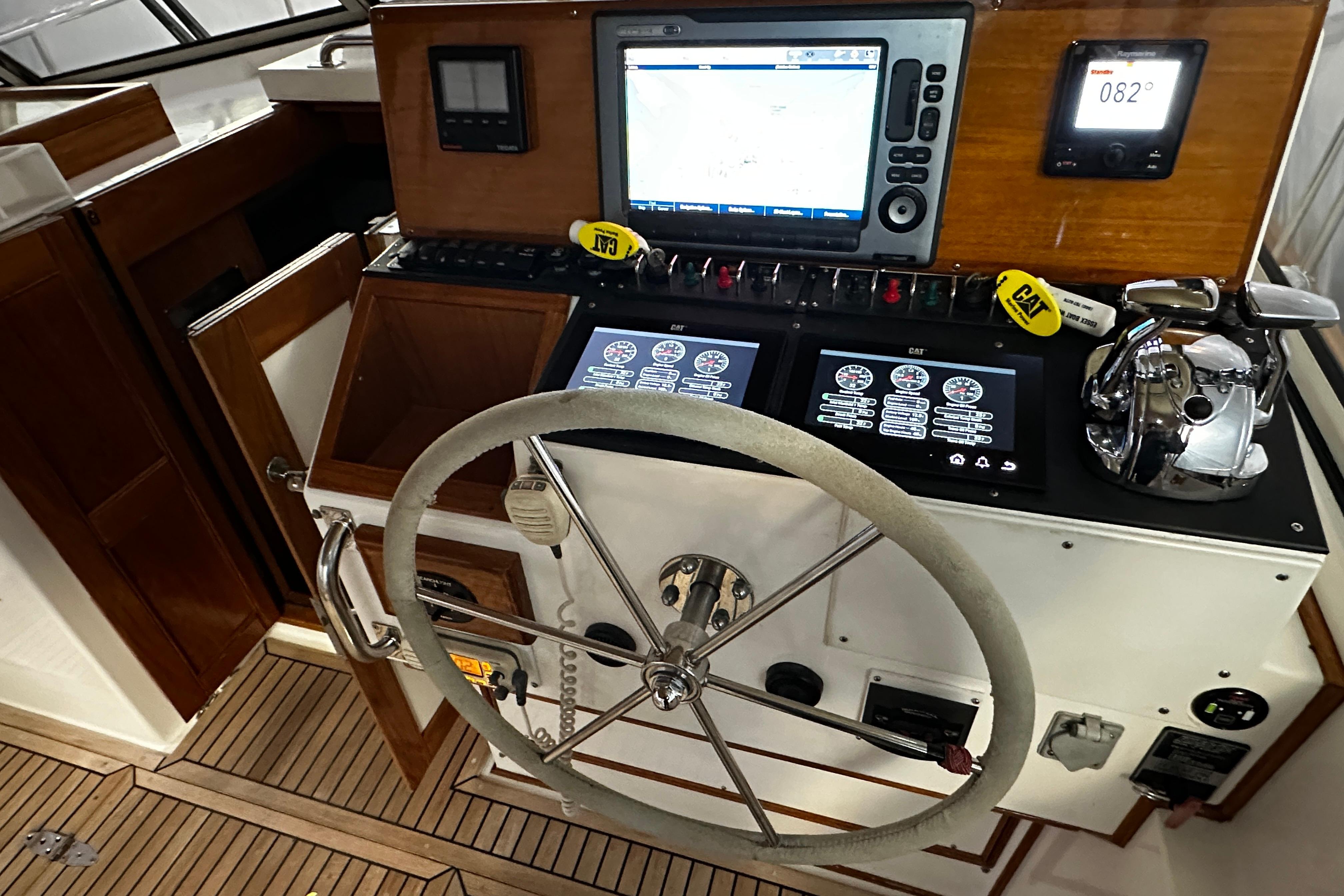 1995 Grand Banks 38 Eastbay EX helm with navigation screens and steering wheel.