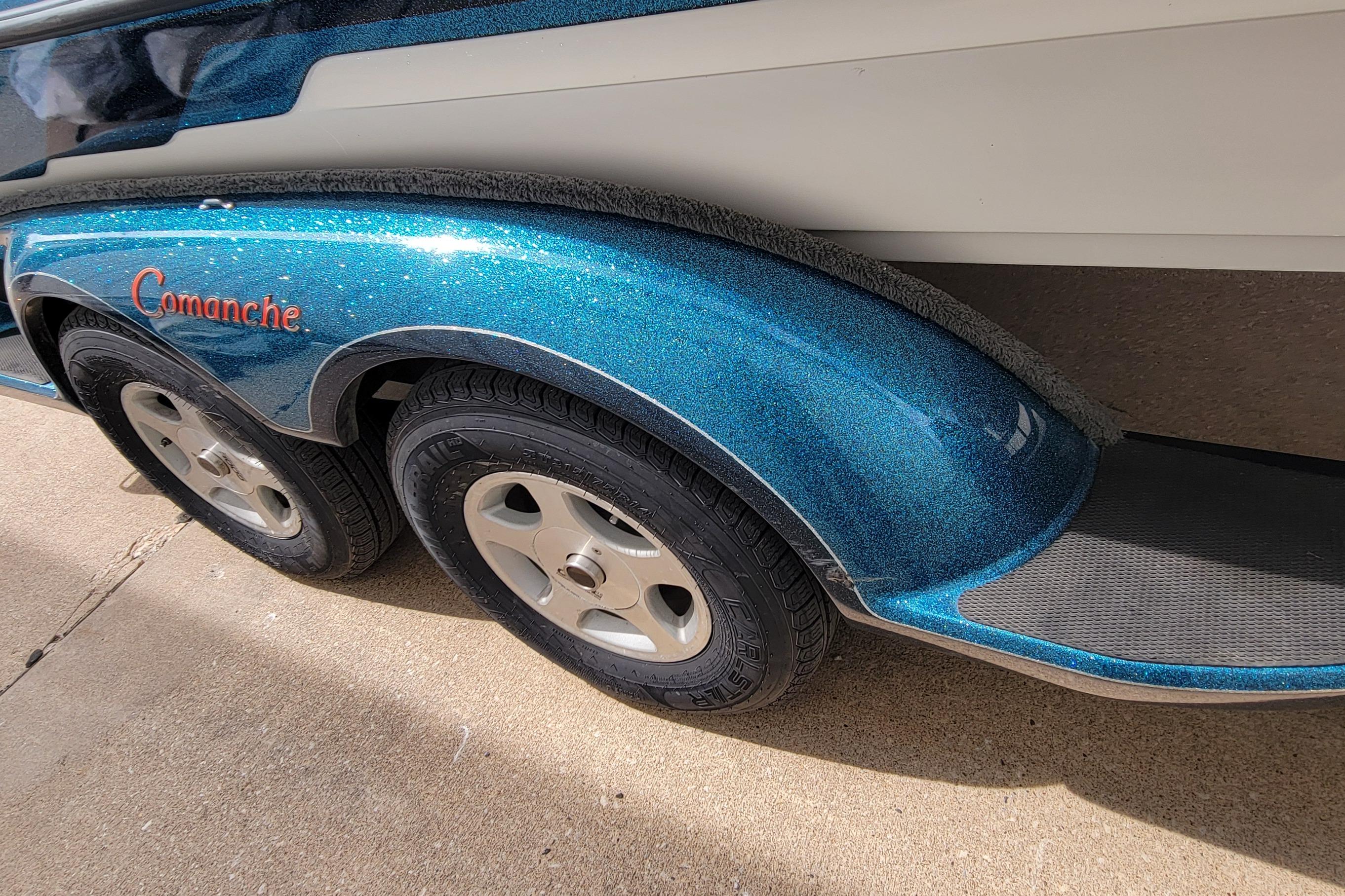 2000 Ranger 522DVX Comanche boat trailer with blue metallic finish and dual wheels.