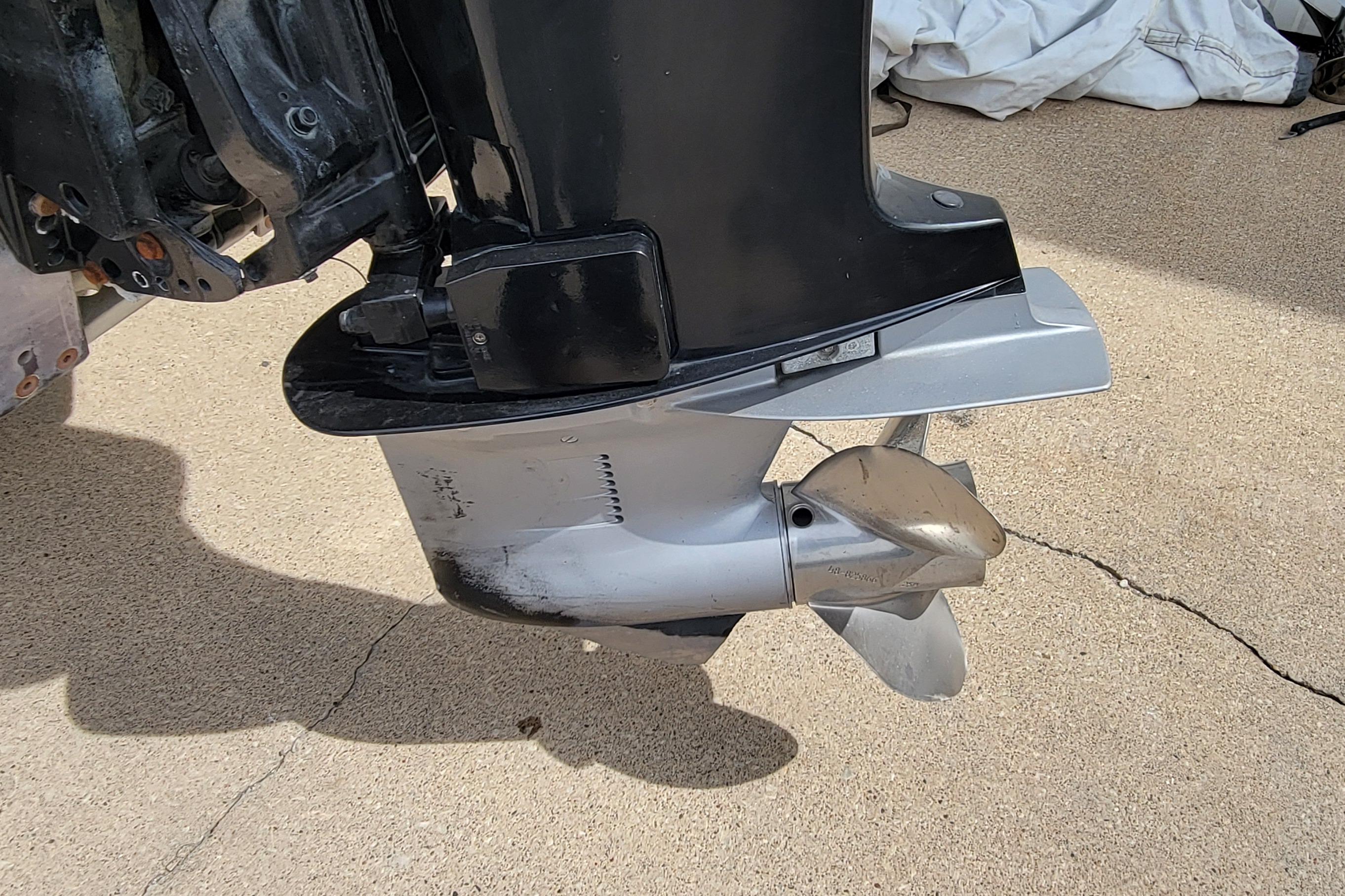 Propeller of a 2000 Ranger 522DVX Comanche boat on concrete surface.