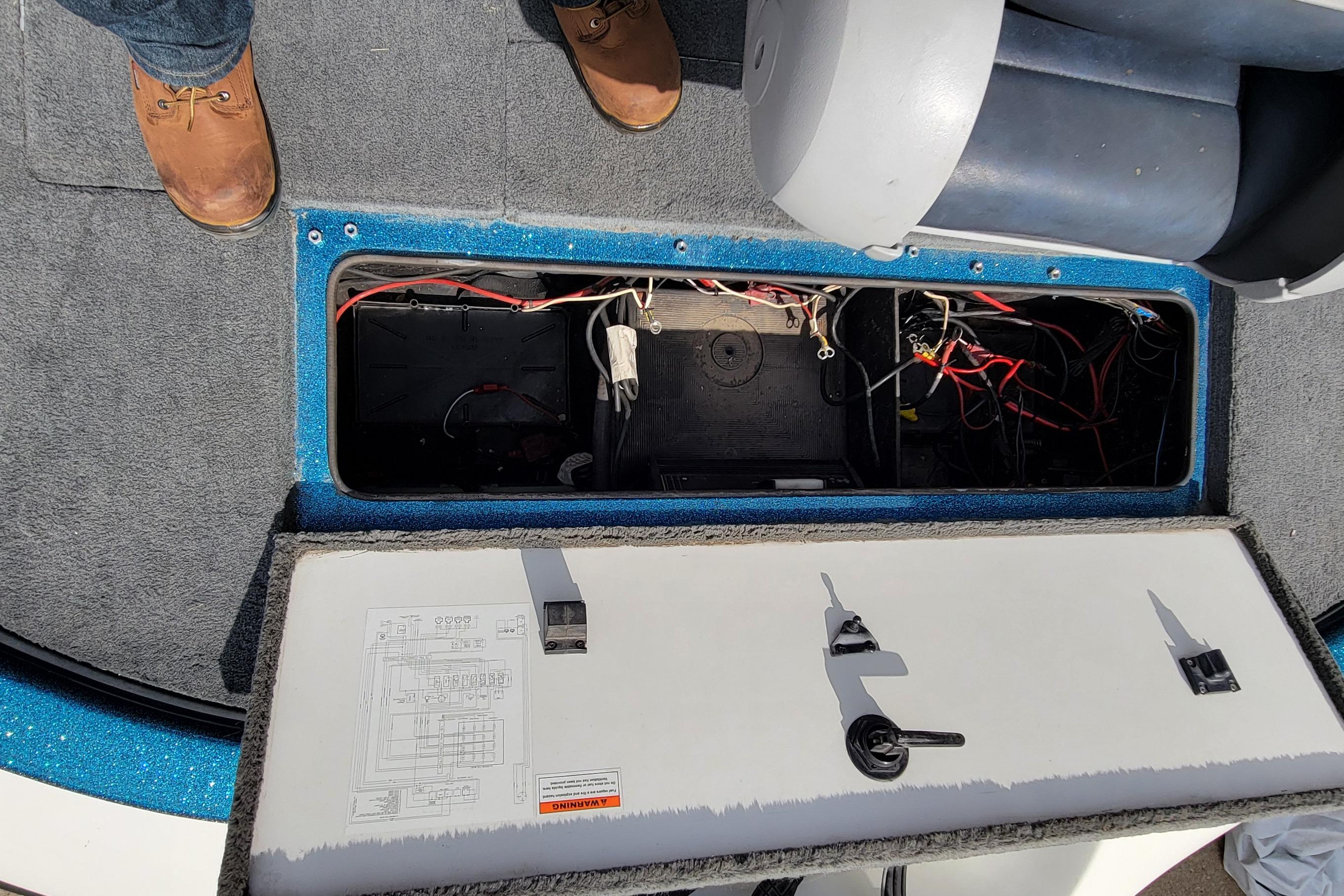 Open hatch of a 2000 Ranger 522DVX Comanche boat showing internal wiring and components.