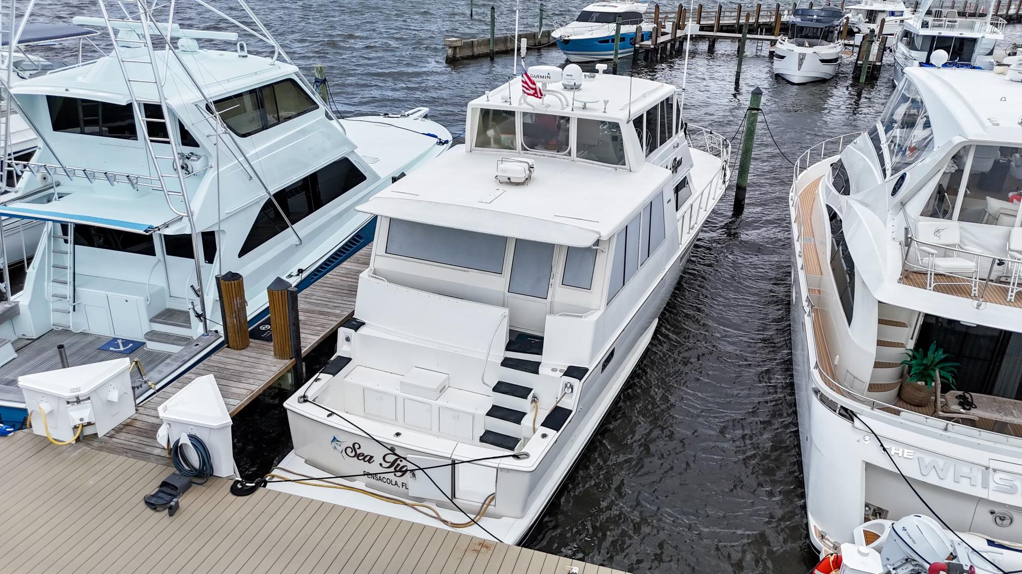 Viking-60 Cockpit Sport Yacht 1996-Sea Tiger FL-US-1996 Viking 60 Cockpit Sport Yacht docked between boats at a marina.-9787053 | Thumbnail