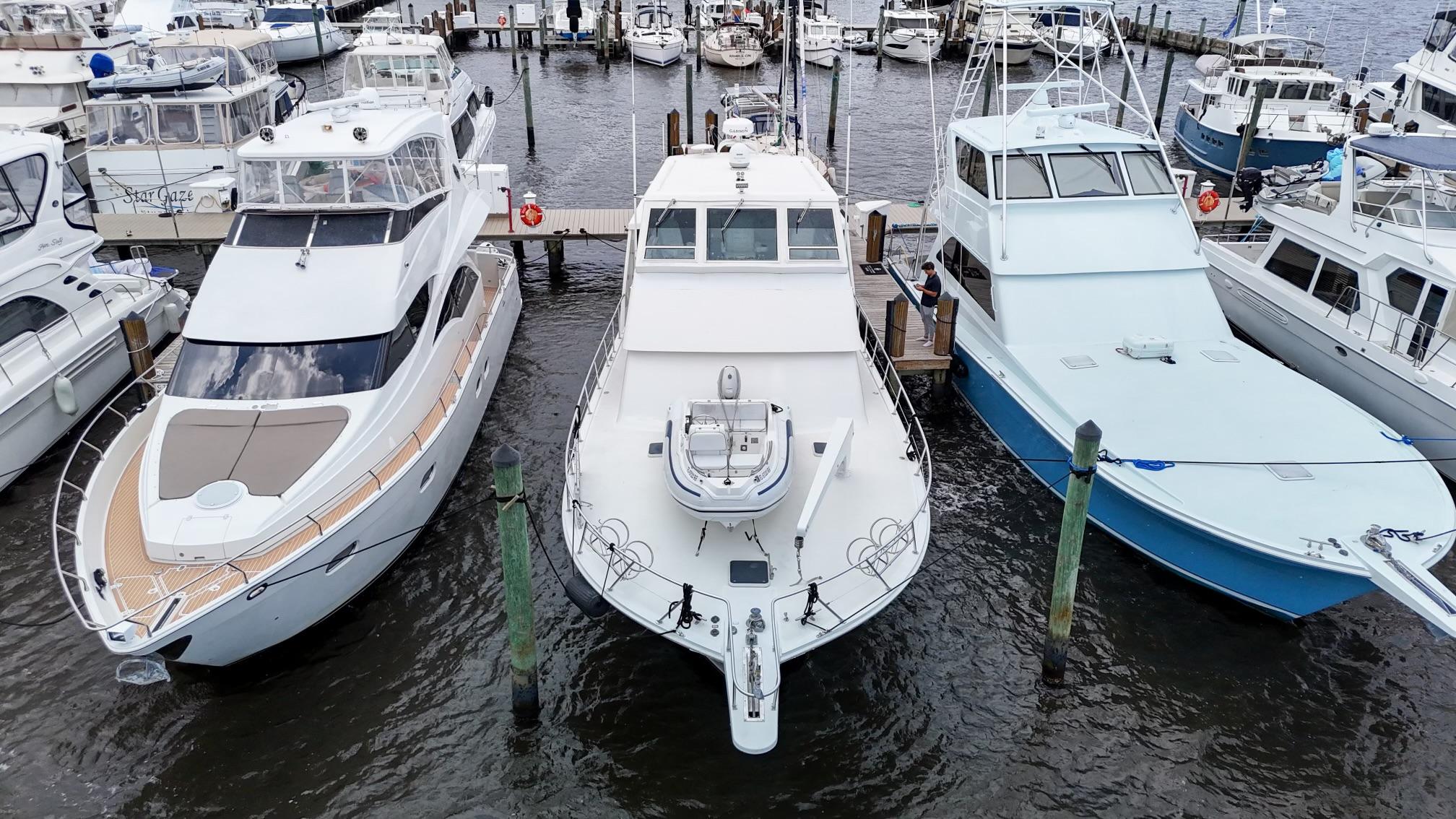 Viking-60 Cockpit Sport Yacht 1996-Sea Tiger FL-US-Three yachts docked at a marina, featuring a 1996 Viking 60 Cockpit Sport Yacht.-9787053 | Thumbnail
