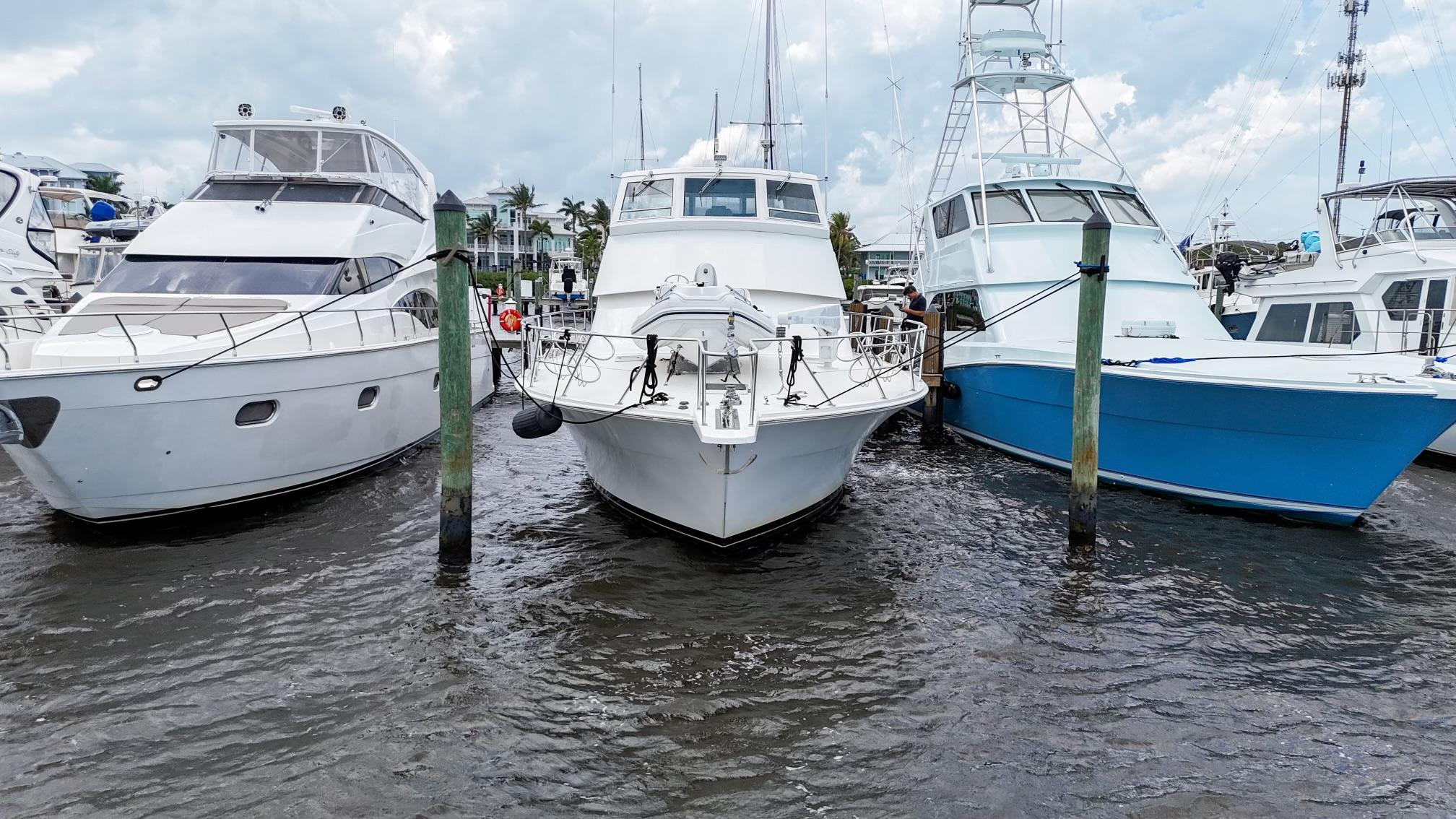 Viking-60 Cockpit Sport Yacht 1996-Sea Tiger FL-US-1996 Viking 60 Cockpit Sport Yacht docked between two boats in a marina.-9787053 | Thumbnail