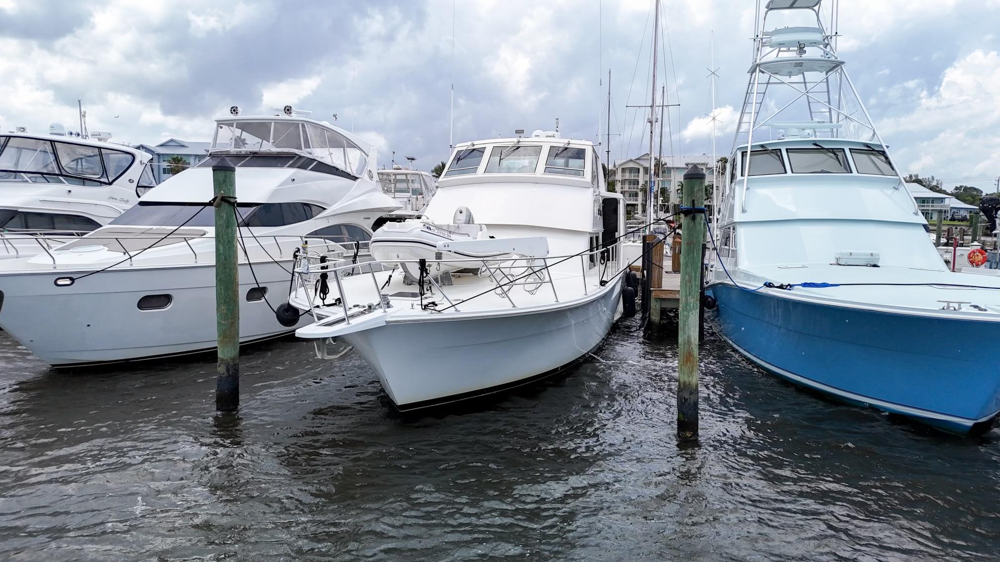 Viking-60 Cockpit Sport Yacht 1996-Sea Tiger FL-US-1996 Viking 60 Cockpit Sport Yacht docked among other boats on a cloudy day.-9787053 | Thumbnail