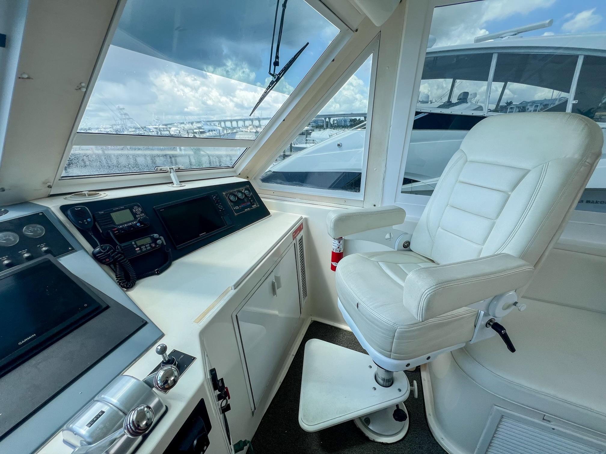 Viking-60 Cockpit Sport Yacht 1996-Sea Tiger FL-US-Helm of 1996 Viking 60 Cockpit Sport Yacht with white captains chair and navigation equipment.-9787053 | Thumbnail