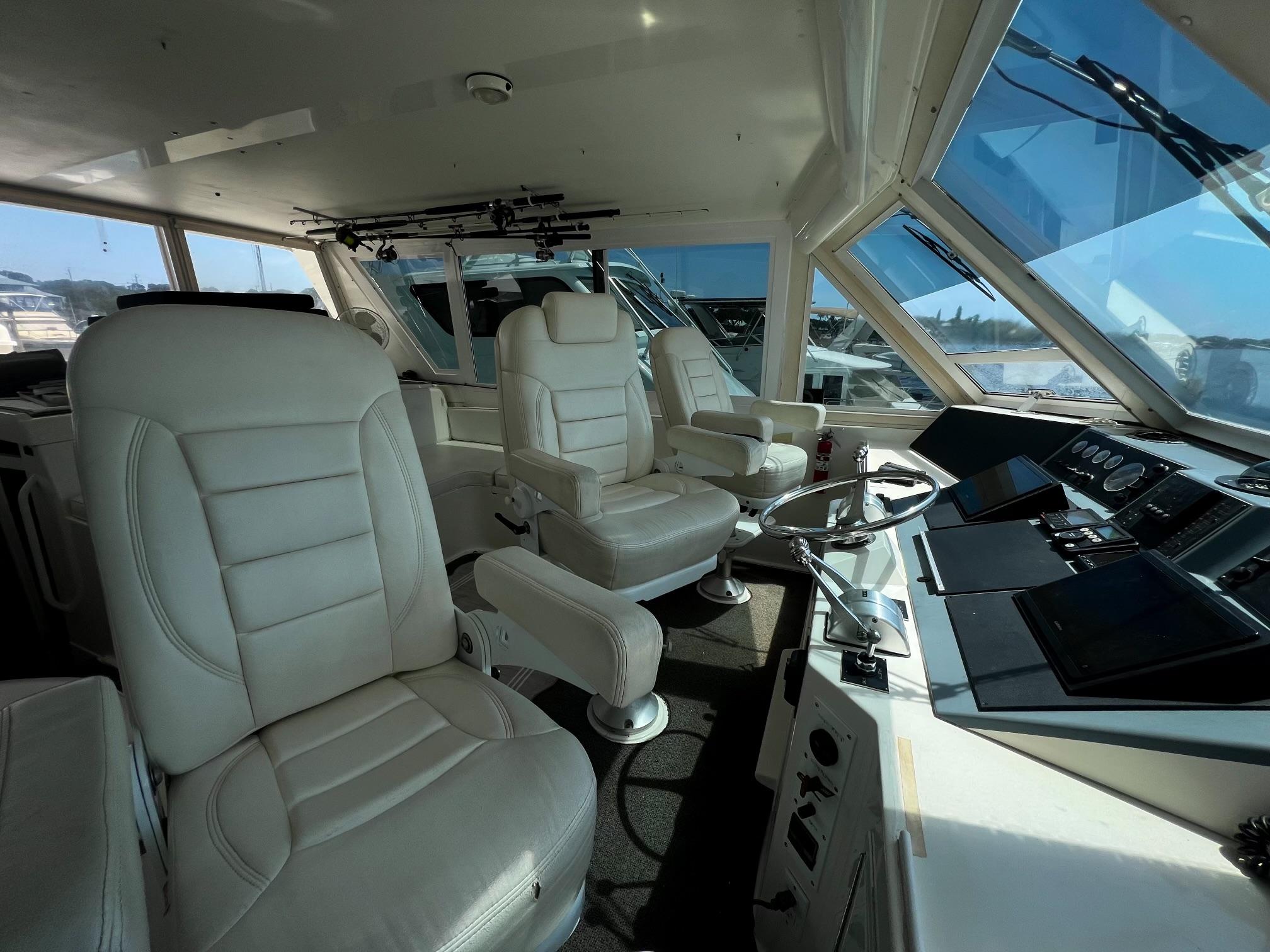 Viking-60 Cockpit Sport Yacht 1996-Sea Tiger FL-US-Interior of 1996 Viking 60 Cockpit Sport Yacht with luxurious white seating and modern controls.-9787053 | Thumbnail