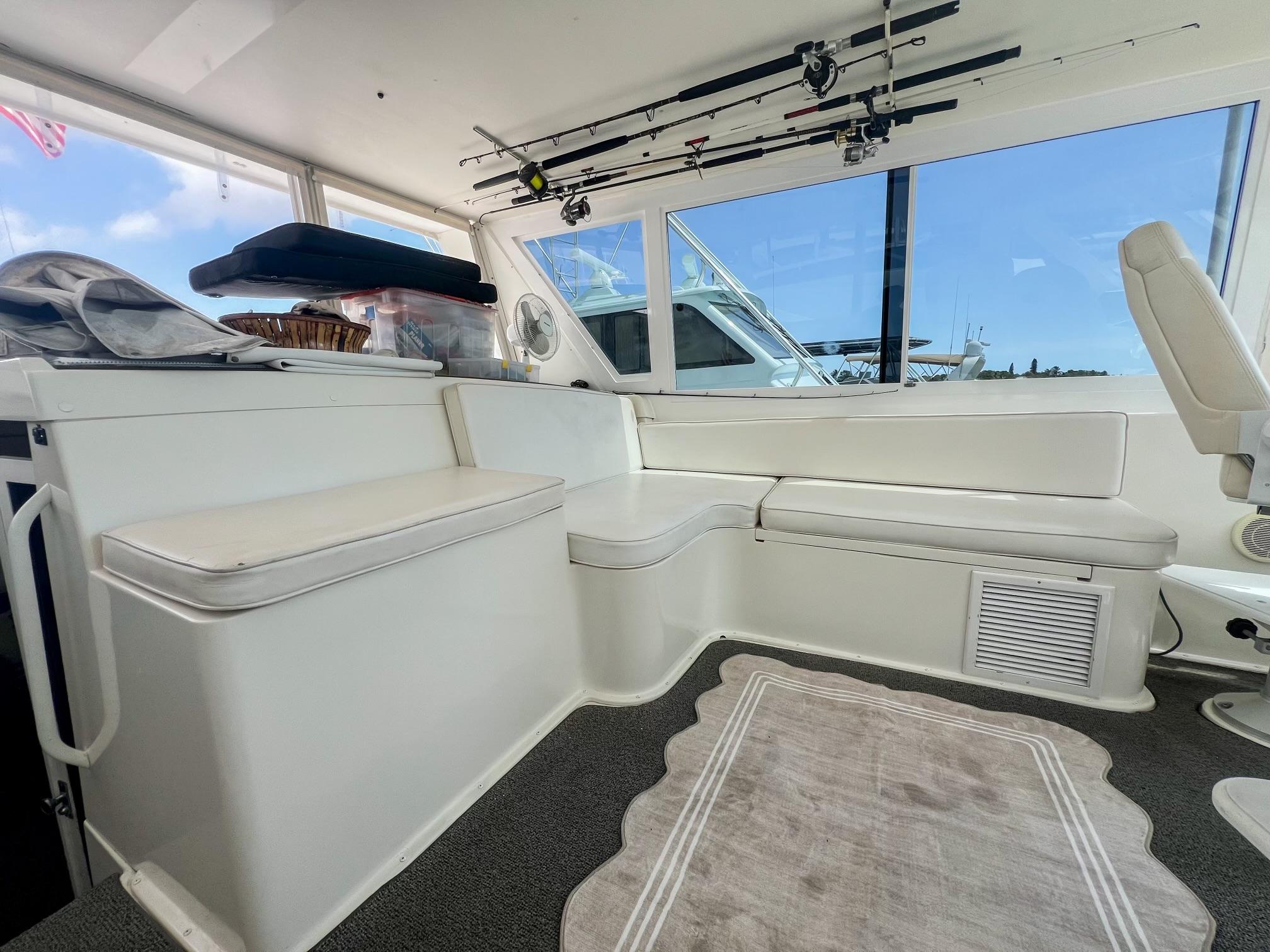 Viking-60 Cockpit Sport Yacht 1996-Sea Tiger FL-US-Interior of 1996 Viking 60 Cockpit Sport Yacht with white seating and fishing rods.-9787053 | Thumbnail