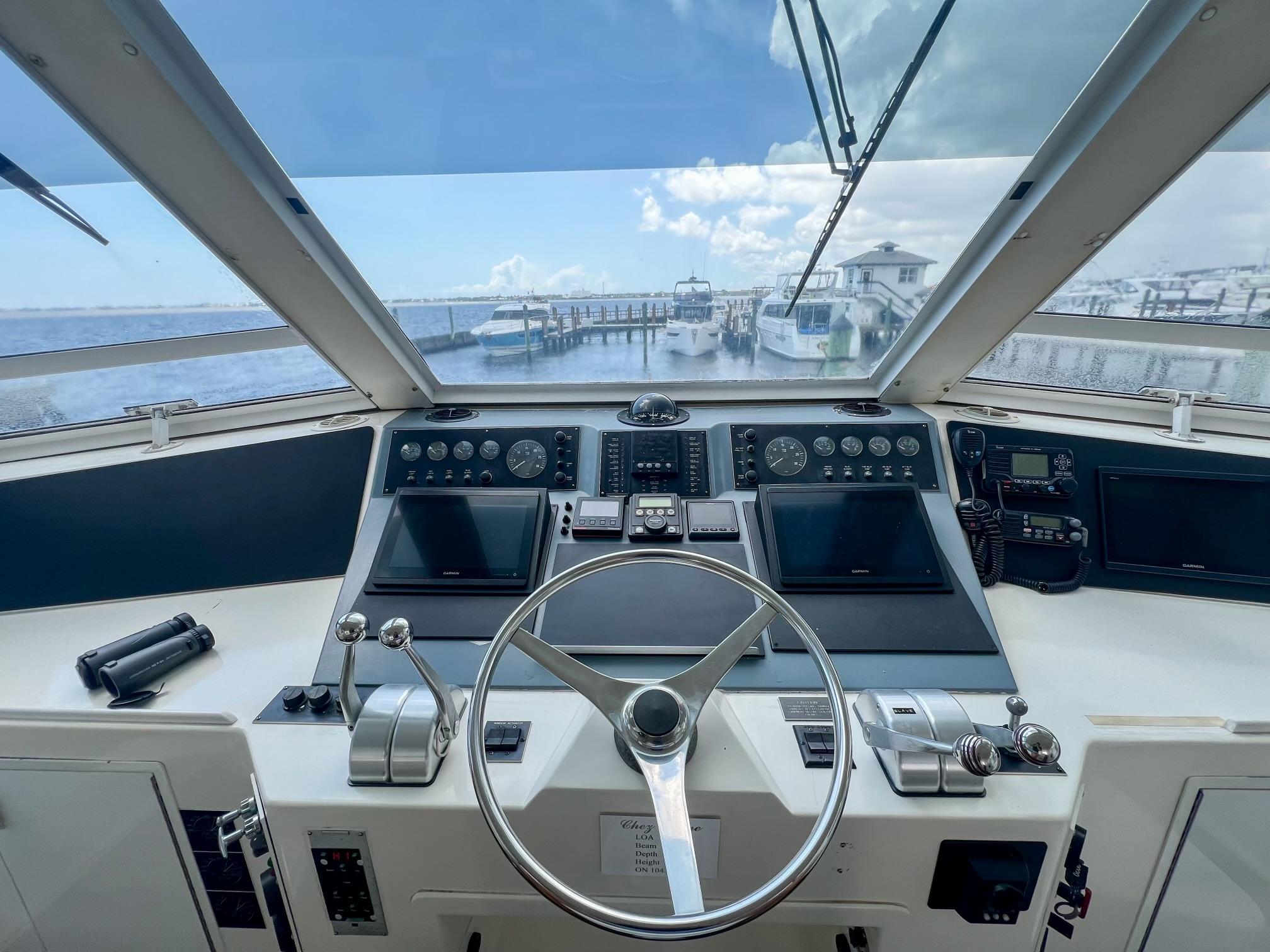 Viking-60 Cockpit Sport Yacht 1996-Sea Tiger FL-US-Cockpit view of a 1996 Viking 60 Cockpit Sport Yacht, showcasing controls and marina backdrop.-9787053 | Thumbnail