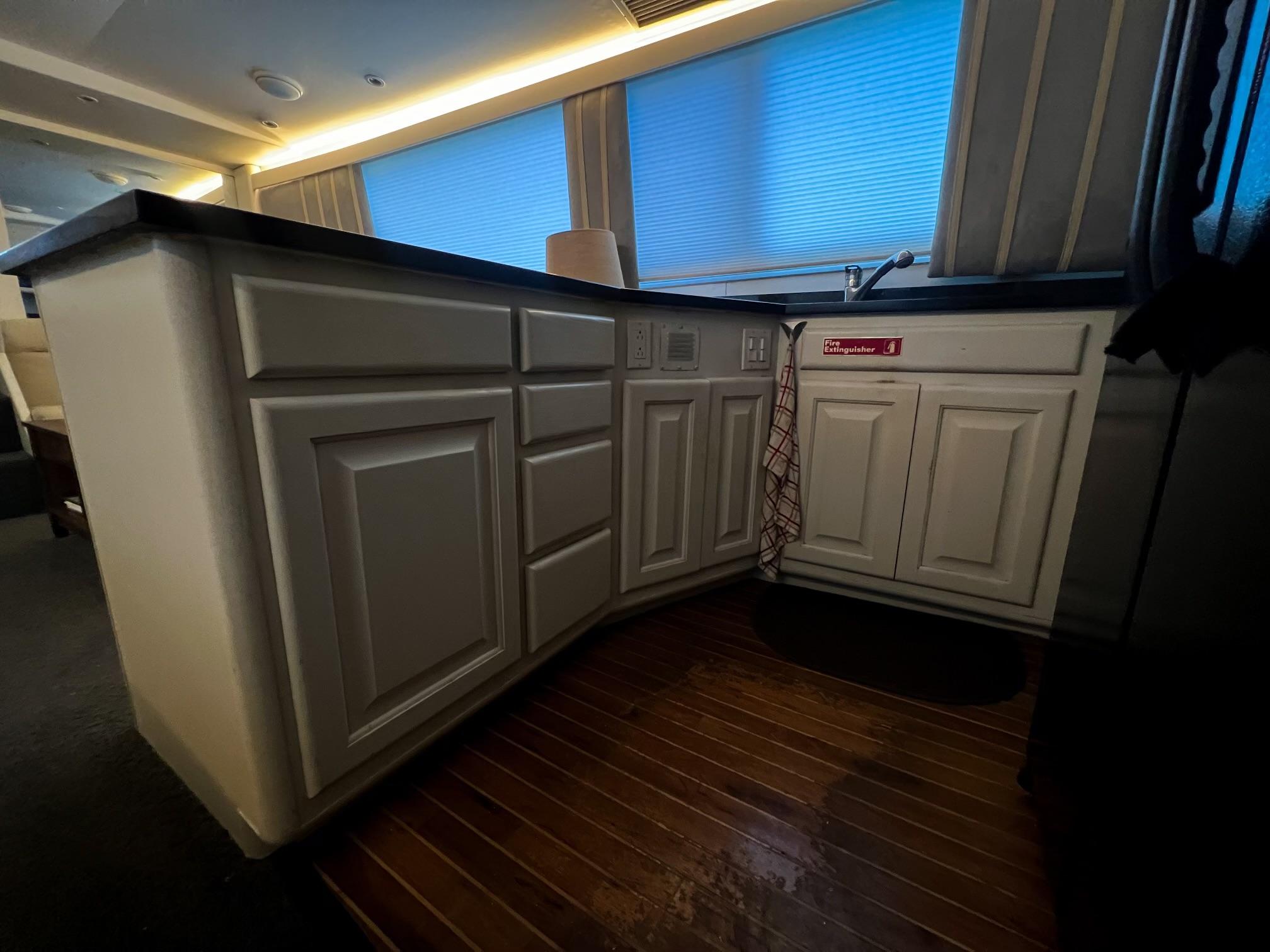 Viking-60 Cockpit Sport Yacht 1996-Sea Tiger FL-US-Interior kitchen of 1996 Viking 60 Cockpit Sport Yacht with wooden flooring and cabinetry.-9787053 | Thumbnail