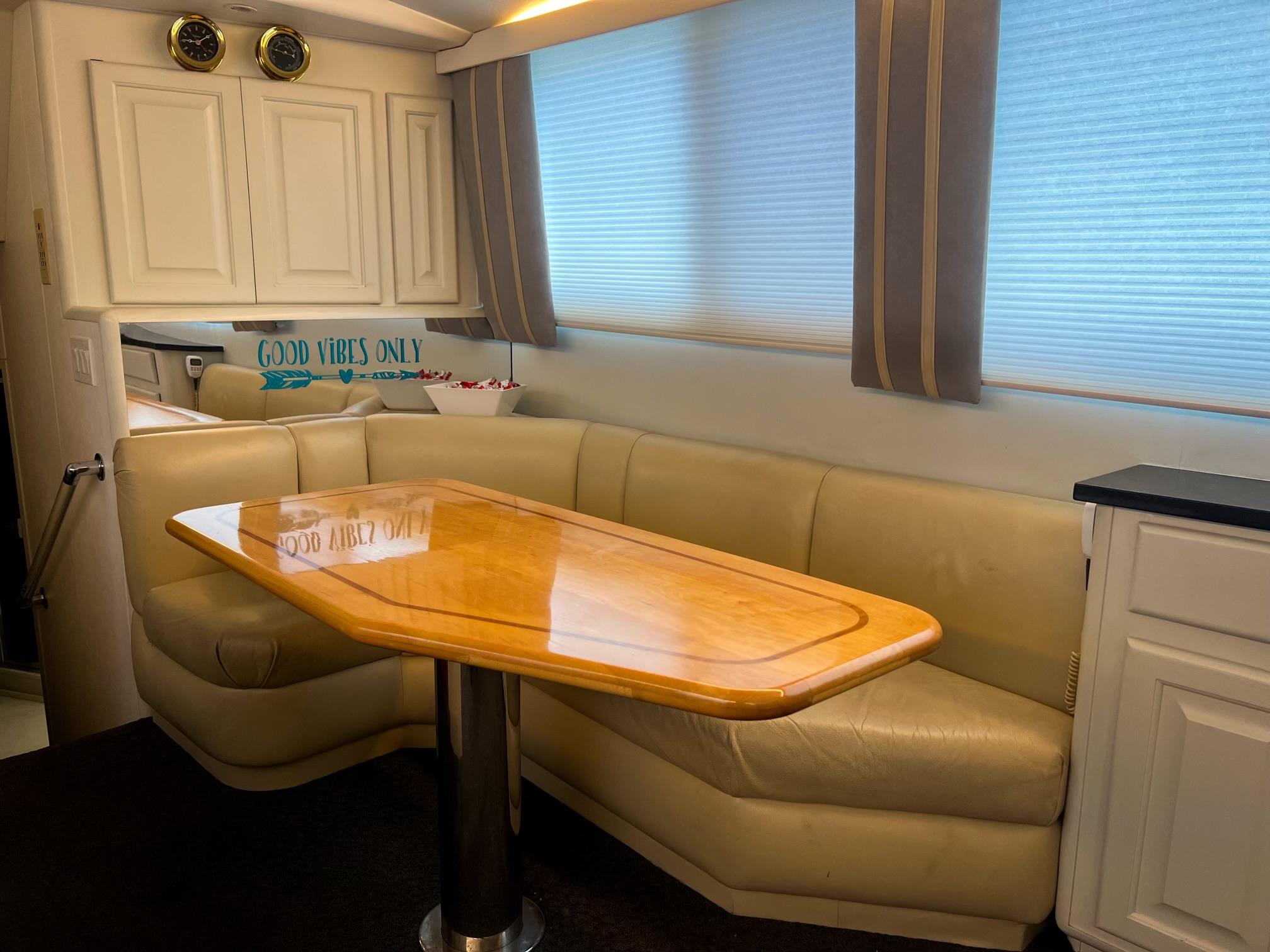 Viking-60 Cockpit Sport Yacht 1996-Sea Tiger FL-US-Interior of 1996 Viking 60 Cockpit Sport Yacht with beige seating and wooden table.-9787053 | Thumbnail