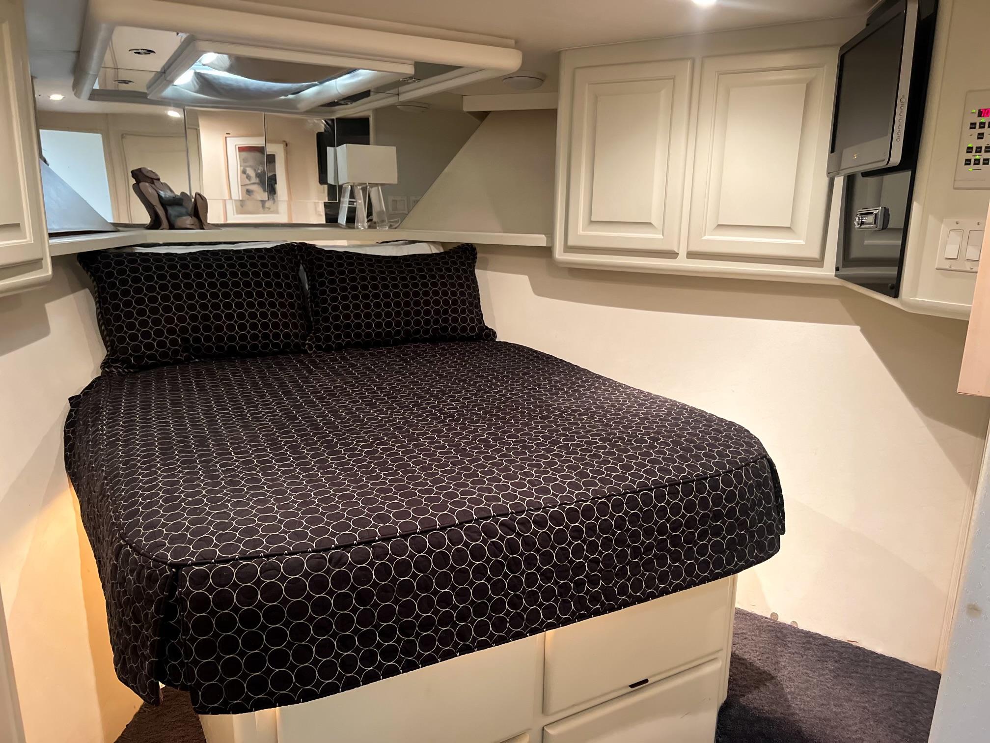 Viking-60 Cockpit Sport Yacht 1996-Sea Tiger FL-US-1996 Viking 60 Cockpit Sport Yacht bedroom with black patterned bedding and white cabinetry.-9787053 | Thumbnail