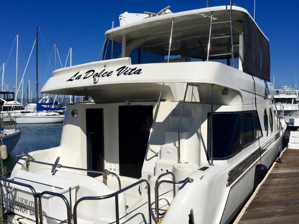 1999 Bluewater 5800 yacht named "La Dolce Vita" docked at marina.