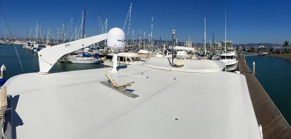 1999 Bluewater 5800 yacht docked in marina, surrounded by boats.