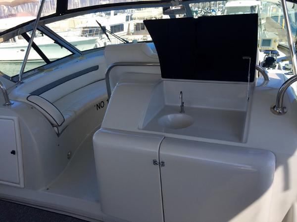 Interior of a 1999 Bluewater 5800 yacht with seating area and sink.