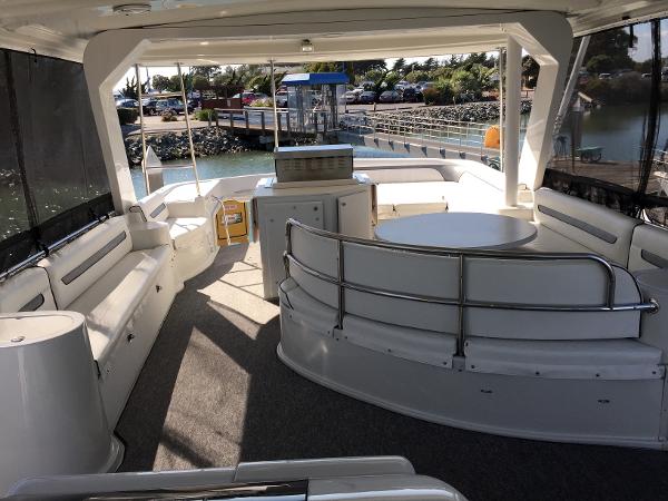 Interior of a 1999 Bluewater 5800 yacht, featuring seating area and table.
