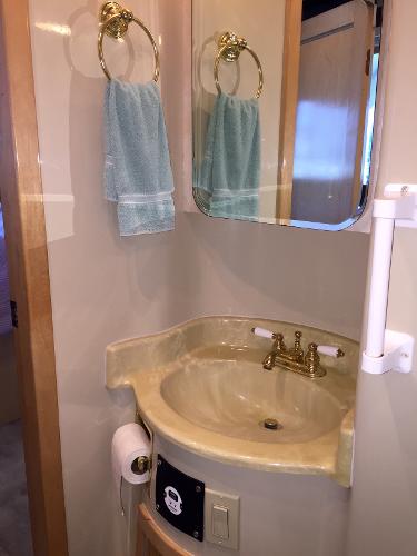 Bathroom in 1999 Bluewater 5800 with sink and mirror.