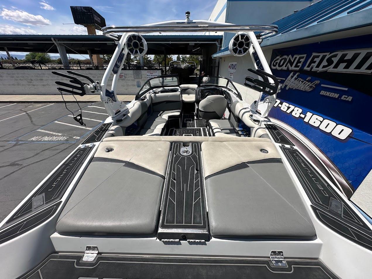 2021 Centurion Fi23 boat interior with seating and wakeboard tower in a parking lot.