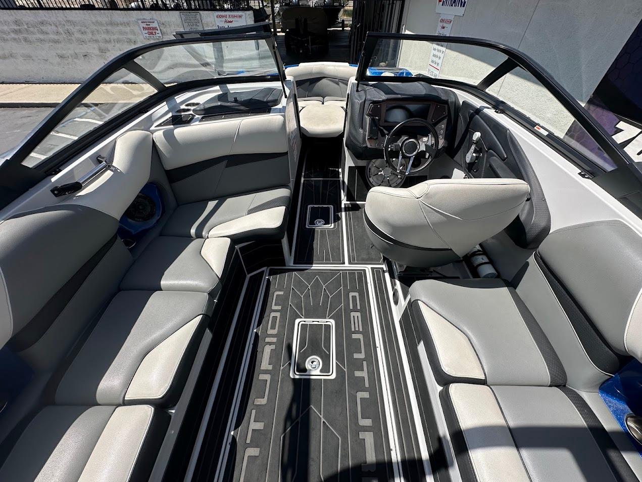 Interior of a 2021 Centurion Fi23 boat with gray seating and modern dashboard.
