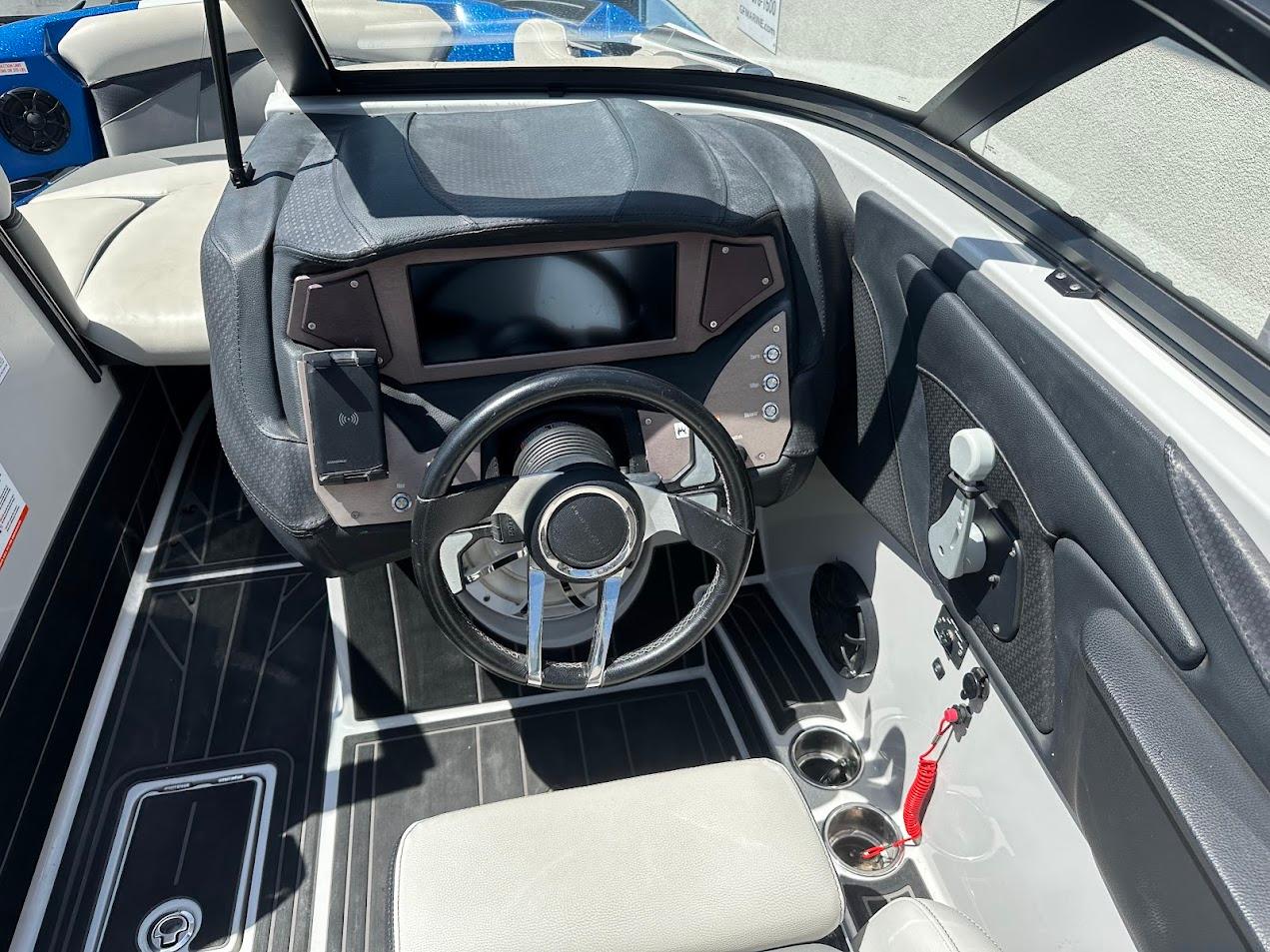 2021 Centurion Fi23 boat interior with steering wheel and control panel.