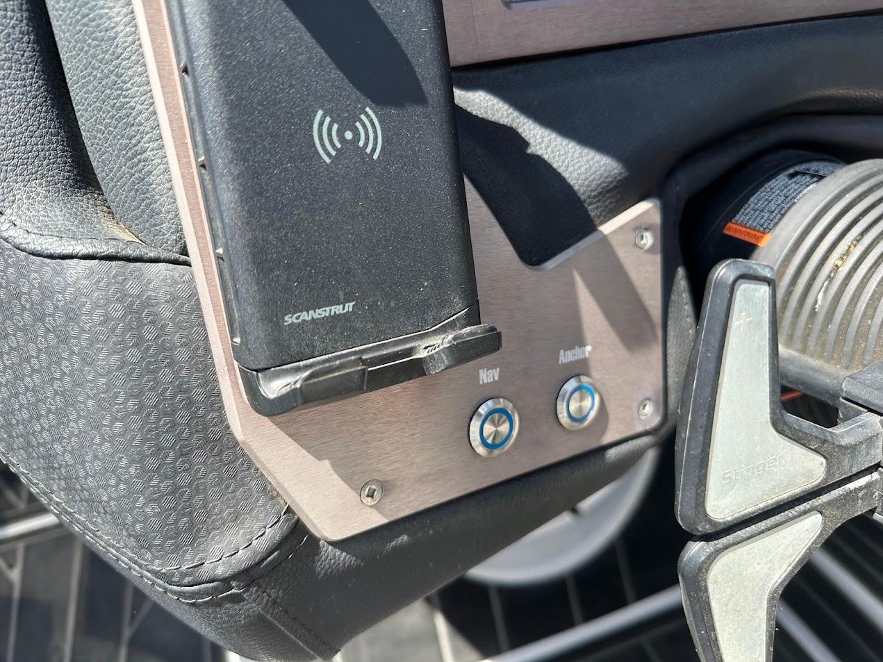 Control panel of a 2021 Centurion Fi23 boat with Scanstrut wireless charger.