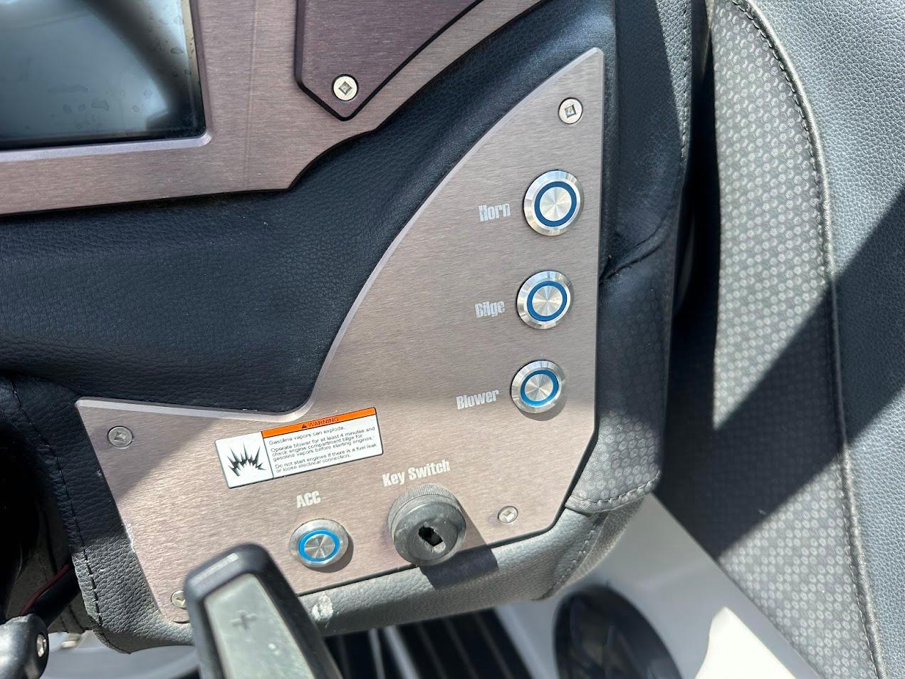 Control panel of a 2021 Centurion Fi23 boat with labeled buttons and key switch.