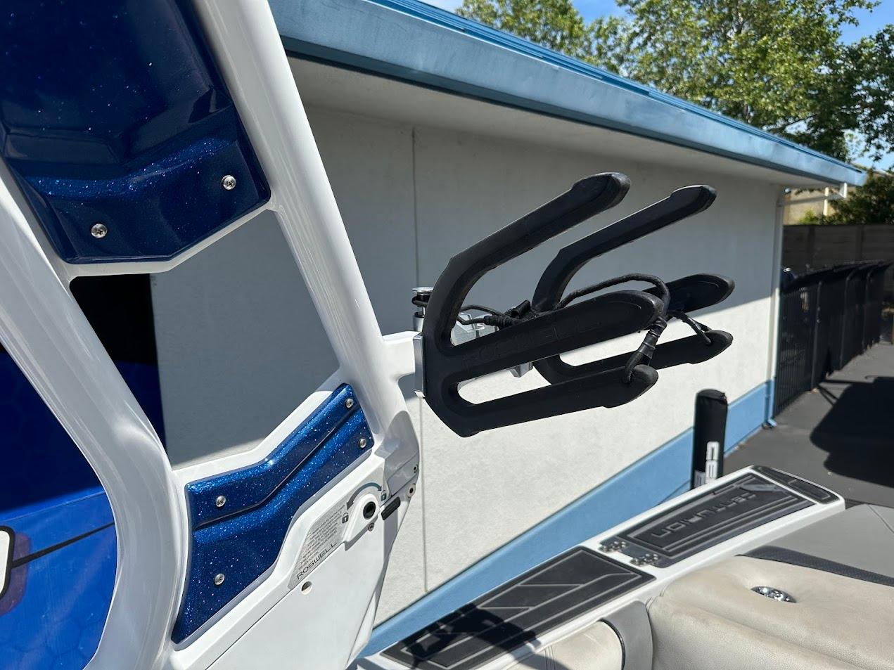 2021 Centurion Fi23 boat with wakeboard rack and blue accents.