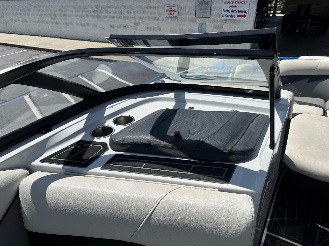 Interior of 2021 Centurion Fi23 boat with cup holders and seating area.