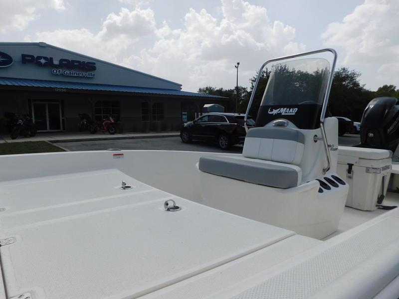 2023 Mako Pro Skiff 15 CC boat at dealership, front seating and console view.