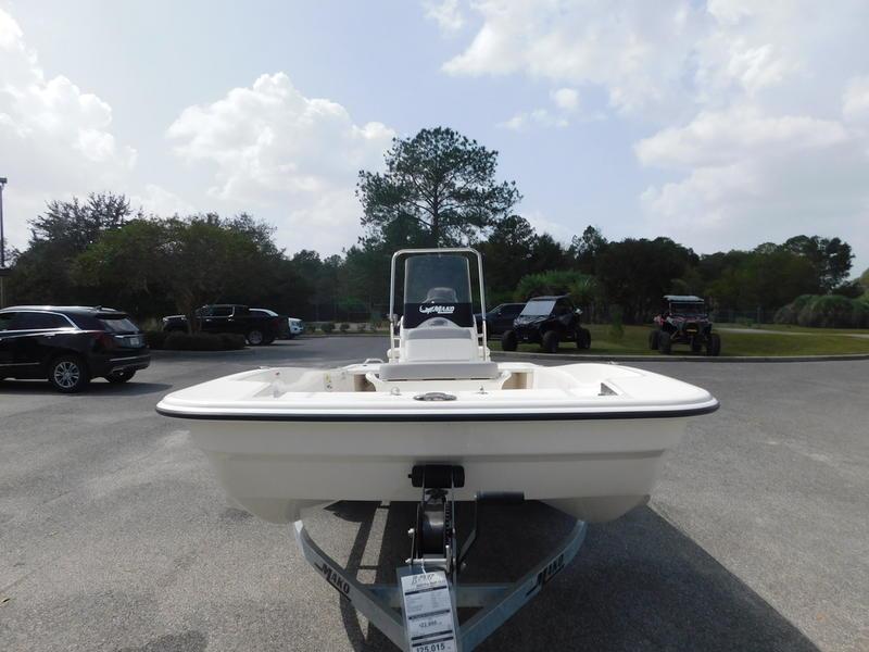 2023 Mako Pro Skiff 15 CC boat on trailer in outdoor parking lot.