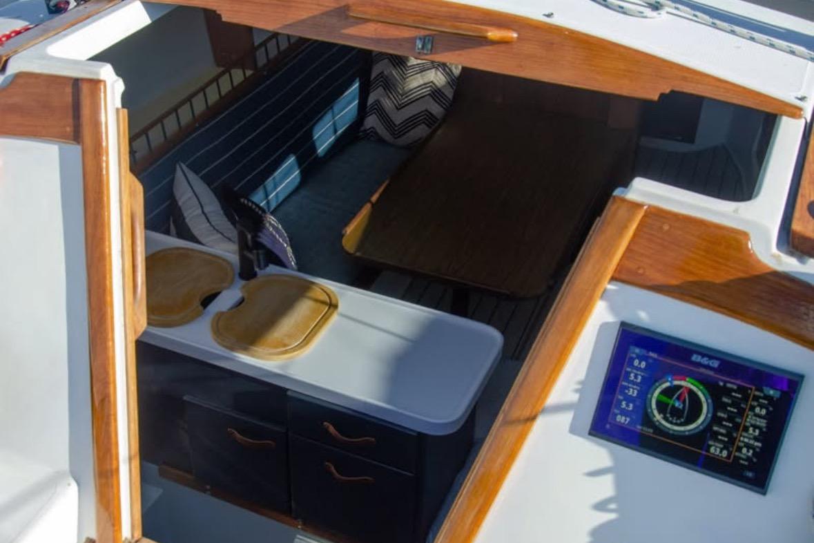 Interior view of a 1981 Catalina 30 sailboat with wooden accents and navigation display.