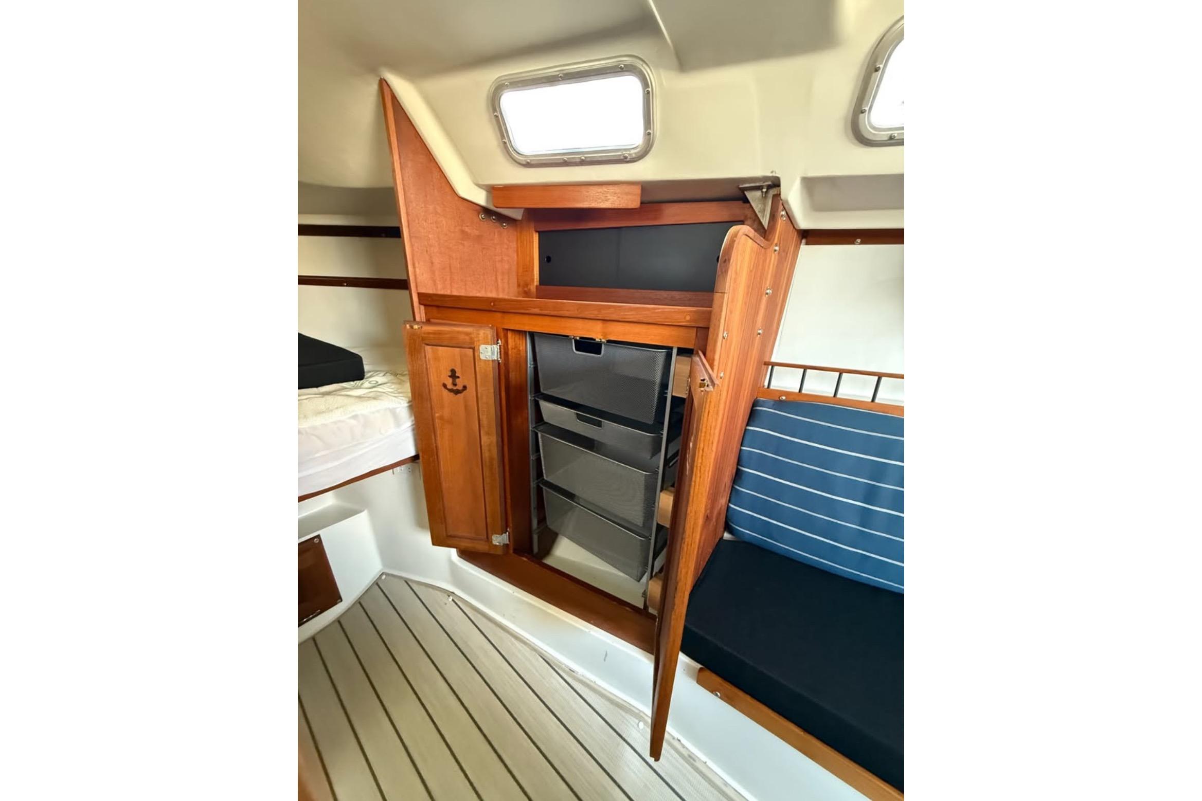 Interior of 1981 Catalina 30 sailboat with wooden cabinetry and seating.