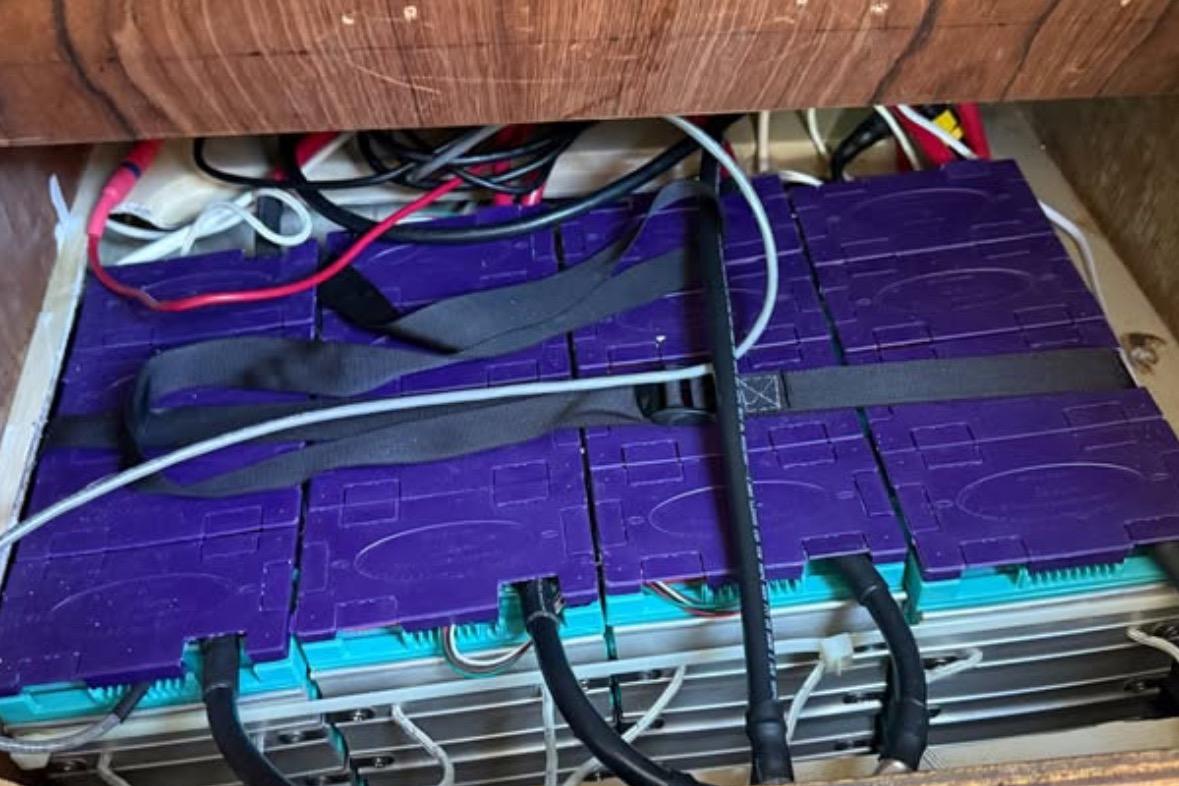 Battery setup in a 1981 Catalina 30 sailboat, featuring purple and blue components.