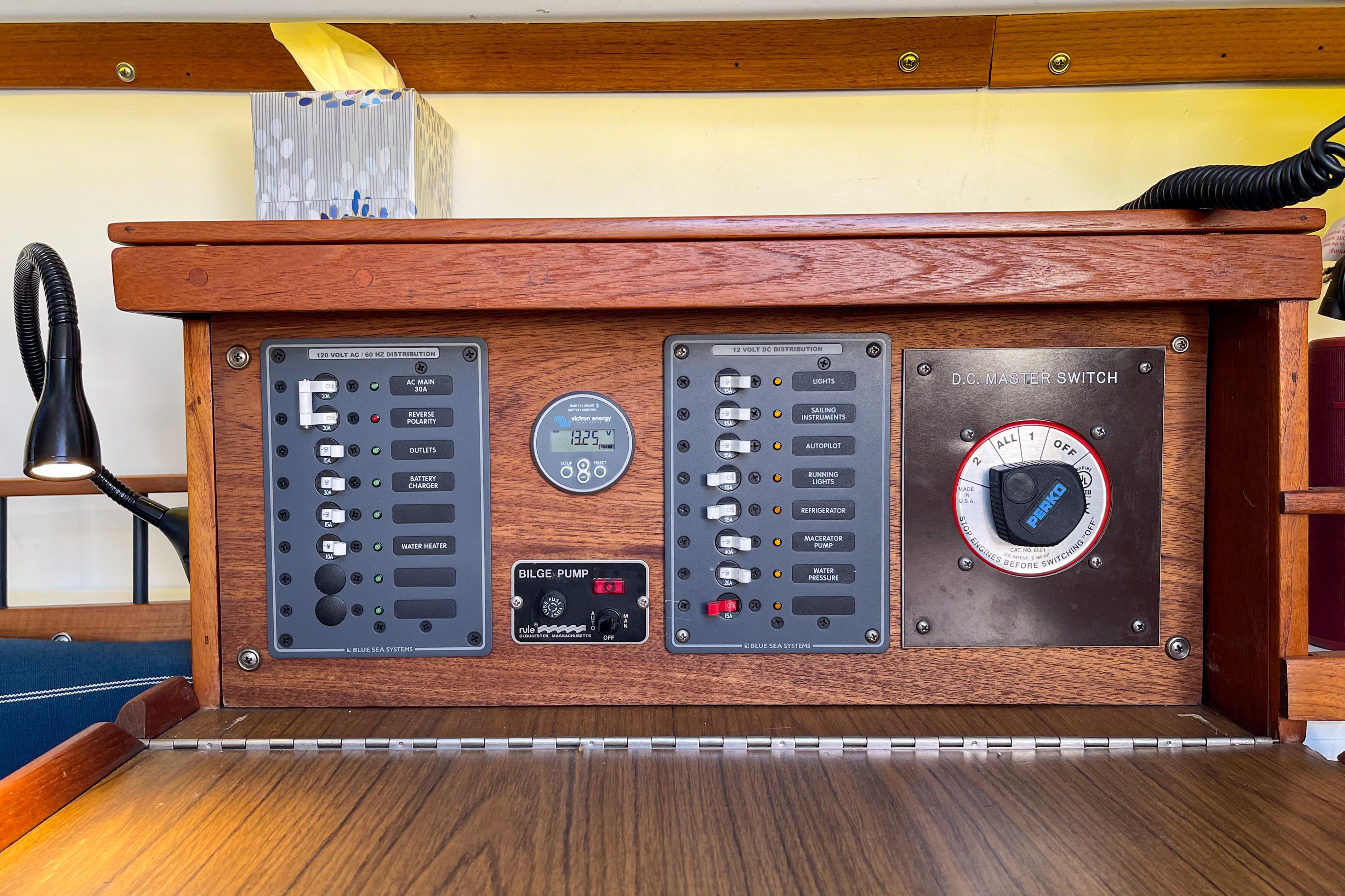 Electrical control panel of a 1981 Catalina 30 sailboat with switches and gauges.