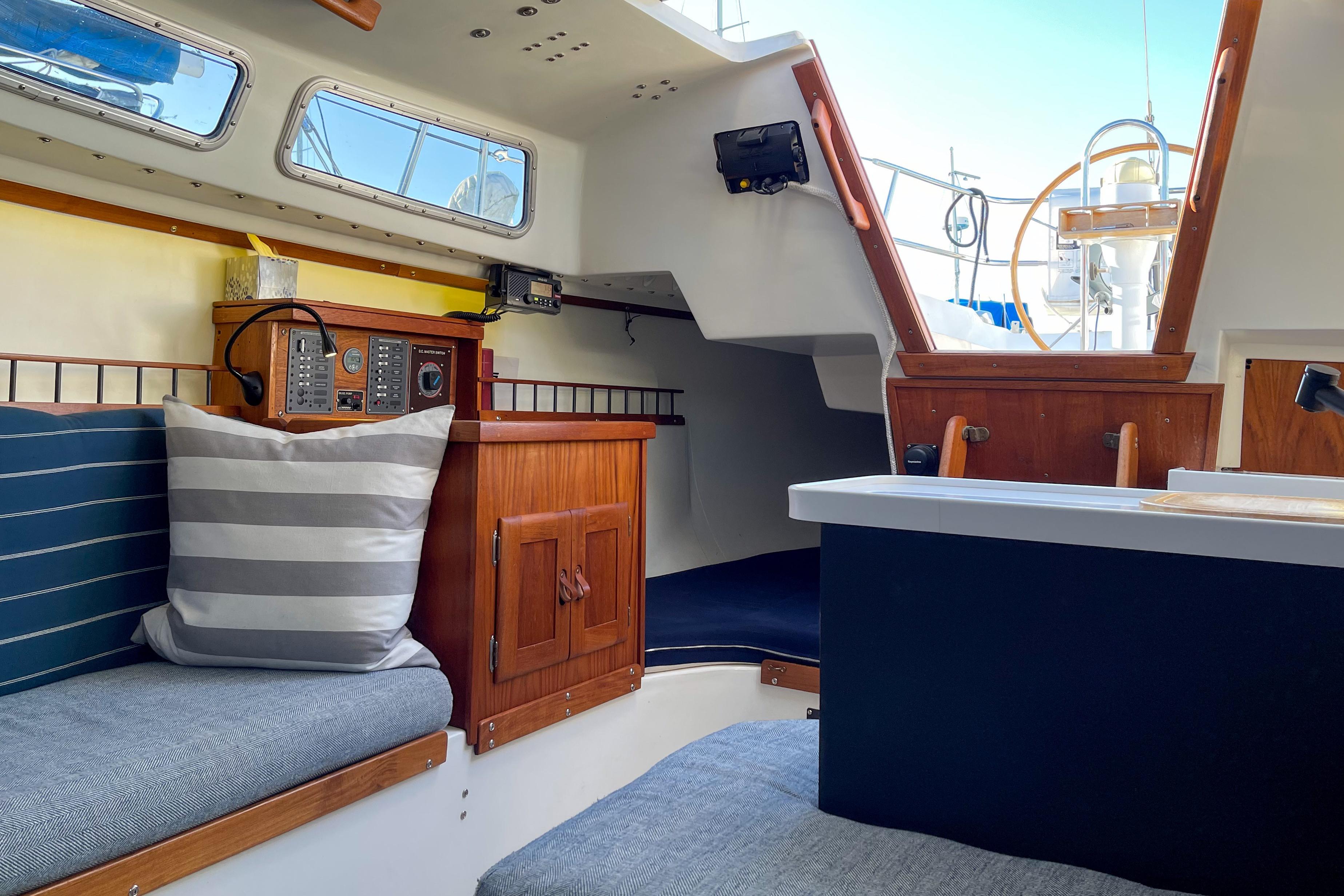 Interior of a 1981 Catalina 30 sailboat with cozy seating and navigation equipment.