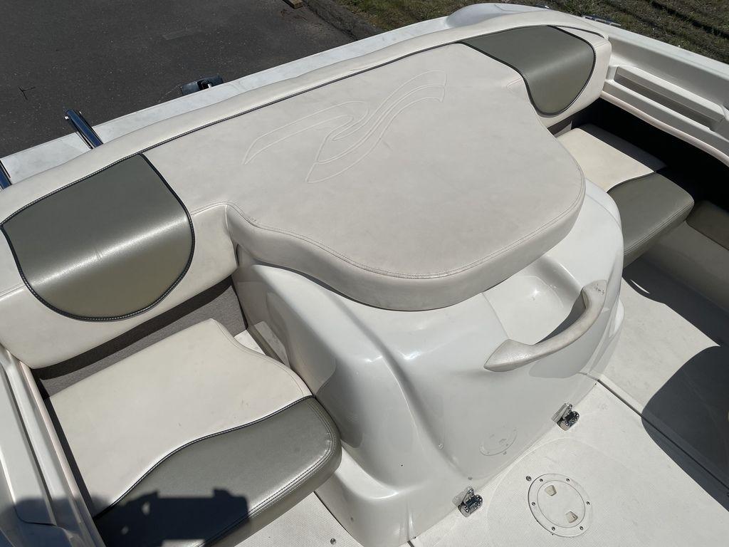 2004 Sea Ray 185 Sport boat interior with cushioned seating and storage.
