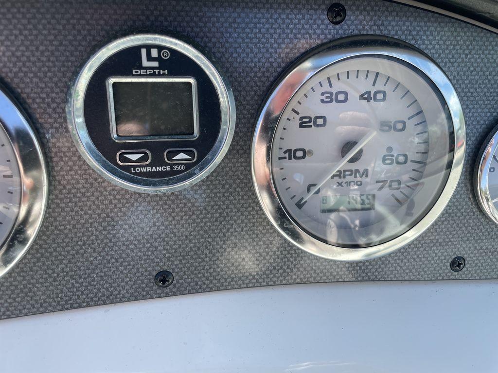 Dashboard of a 2004 Sea Ray 185 Sport boat with depth gauge and RPM meter.