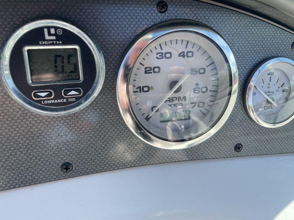 Dashboard of a 2004 Sea Ray 185 Sport boat showing depth and RPM gauges.