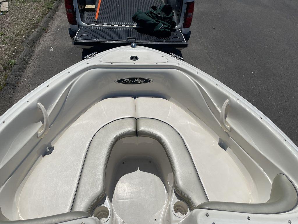 2004 Sea Ray 185 Sport boat interior with white seating and logo.