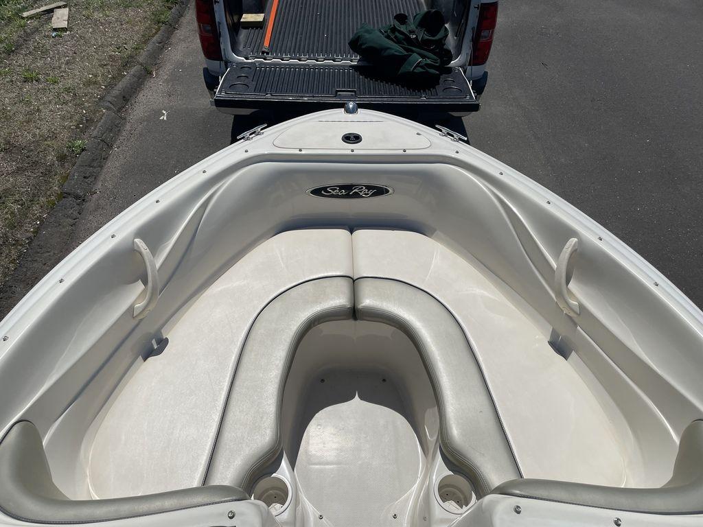 2004 Sea Ray 185 Sport boat interior with seating, parked near a truck.