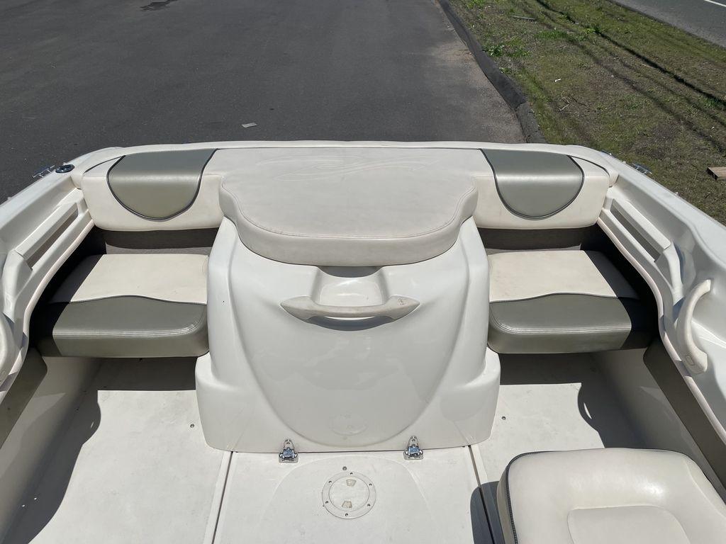 2004 Sea Ray 185 Sport boat interior with cushioned seating and storage.