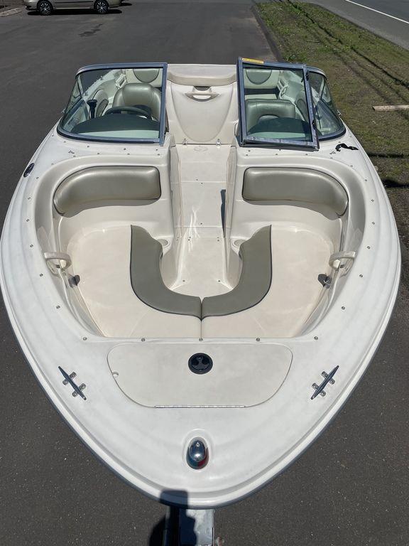 2004 Sea Ray 185 Sport boat with open bow seating and dual windshields.