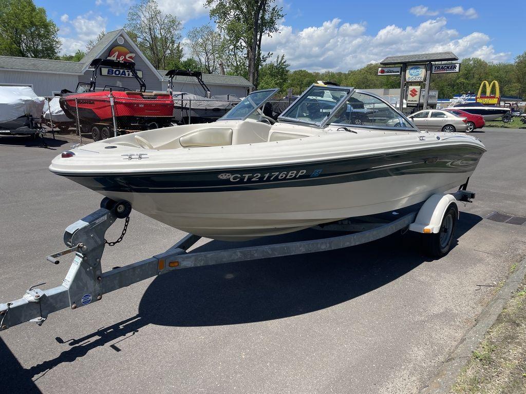 2004 Sea Ray 185 Sport boat on trailer in parking lot, sunny day.