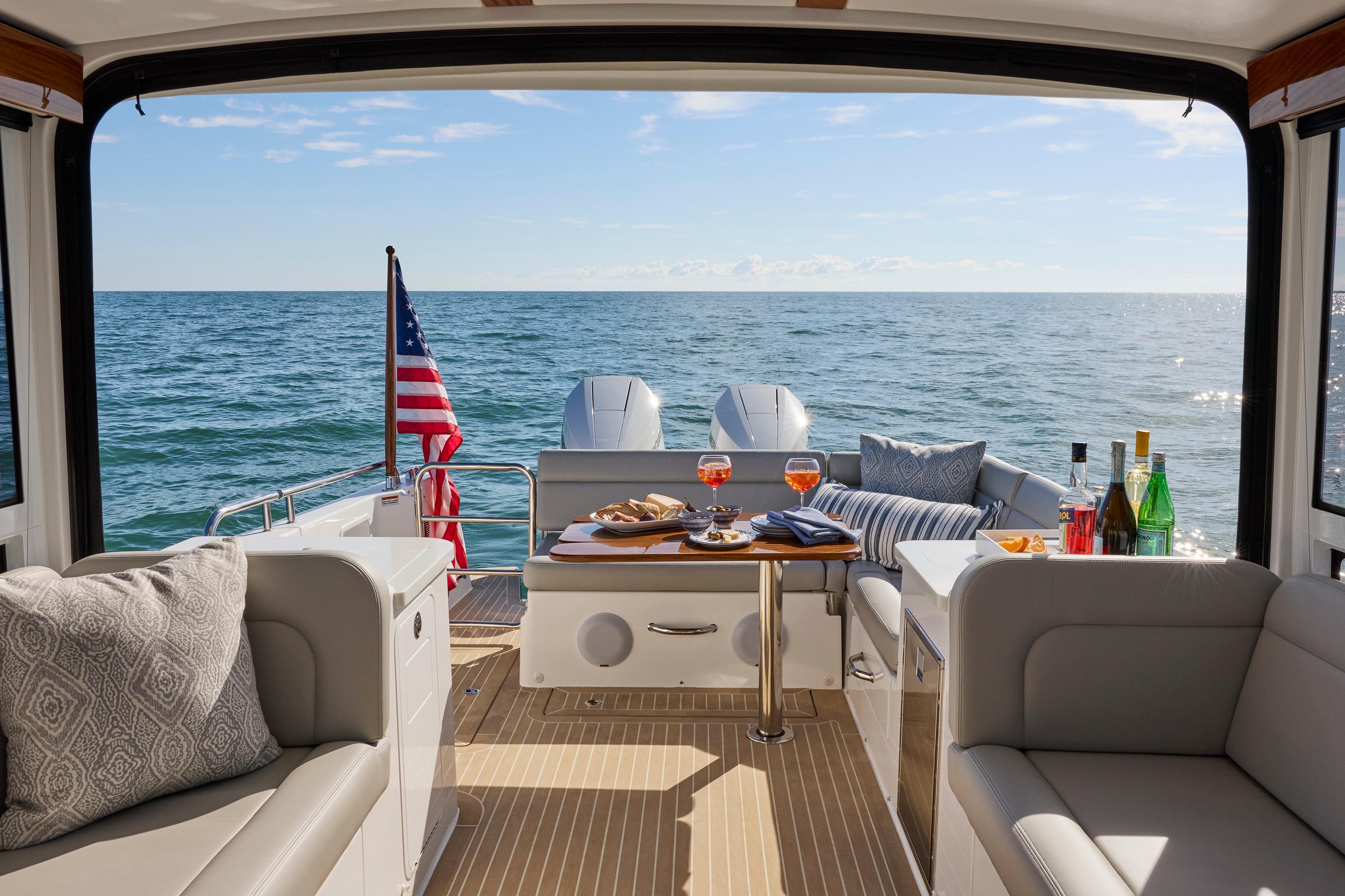 Luxurious 2026 MJM 38 X yacht interior with ocean view, featuring elegant seating and refreshments.