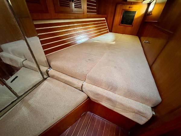 Cozy cabin interior of 1983 Tayana 52 Aft Cockpit yacht with cushioned seating.