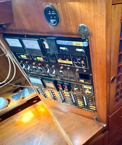 Control panel of 1983 Tayana 52 Aft Cockpit sailboat with various switches and gauges.