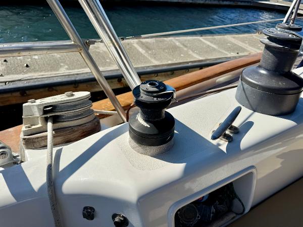 Deck equipment on 1983 Tayana 52 Aft Cockpit sailboat, featuring winches and railing.