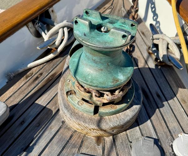 Vintage 1983 Tayana 52 Aft Cockpit sailboat winch on wooden deck.