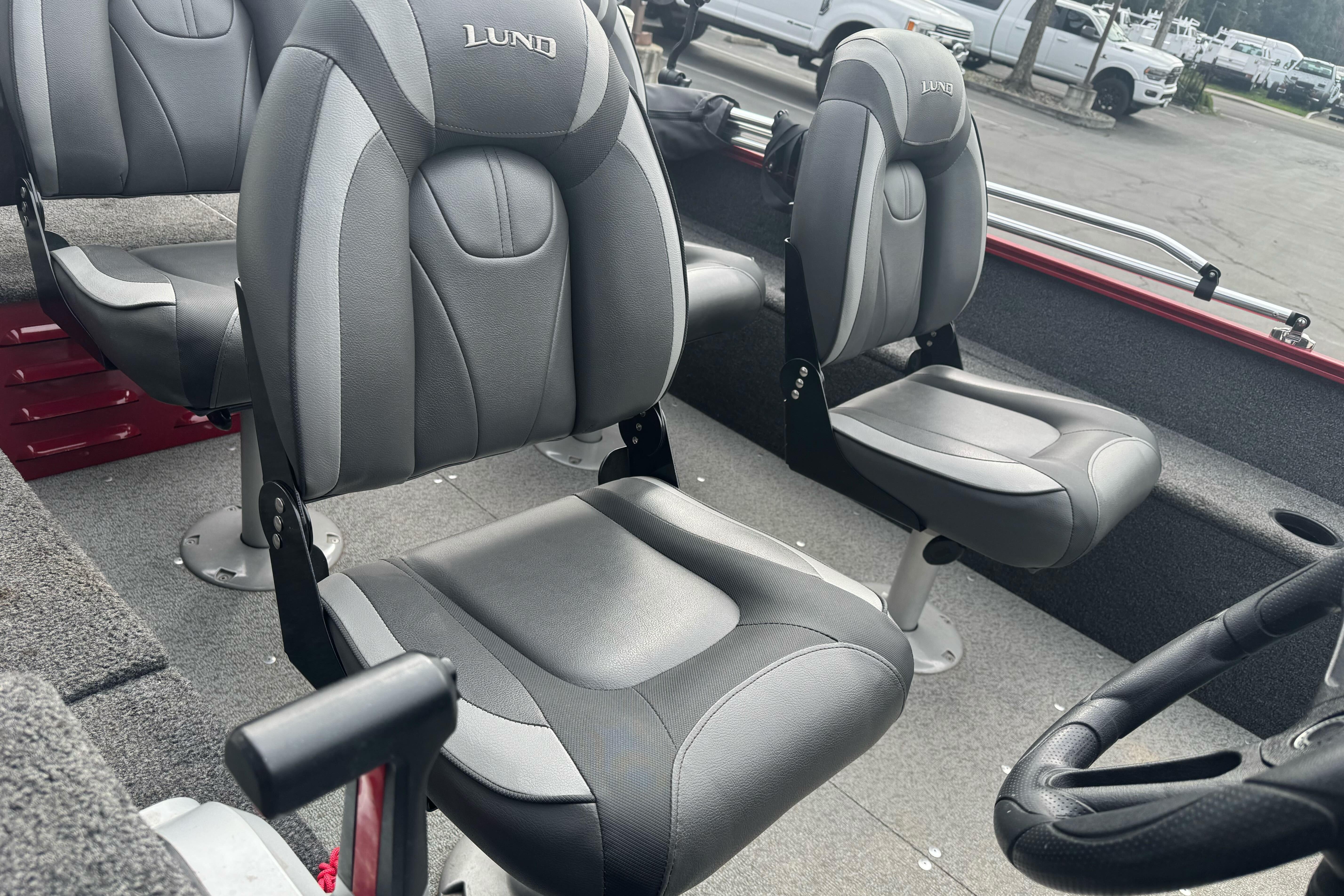 2021 Lund 1650 Angler SS boat interior with gray seating and steering wheel.